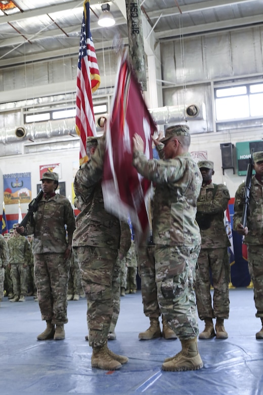 Col. Bruce Syvinski (right), the commander of the 86th Combat Support Hospital, and Command Sgt. Maj. Daryl Forsythe, the command sergeant major for the 86th CSH, releases the unit’s colors to their upright position, during the transfer of authority ceremony, in the Zone 1 Fitness Center, Camp Arifjan, Kuwait, May 5. The ceremony transfers the authority of the United States Military Hospital- Kuwait from the 31st CSH to the 86th CSH. (U.S. Army photo by Sgt. Bethany Huff, ARCENT Public Affairs)