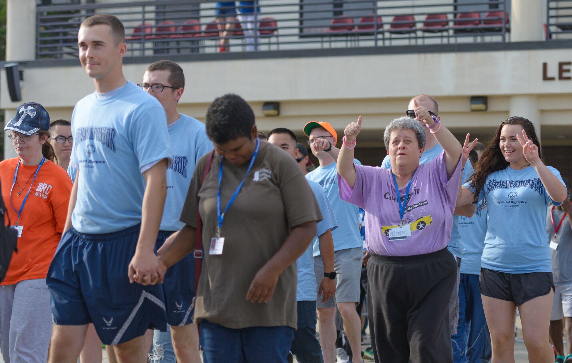 Airmen sponsors and athletes walk onto the Levitow Training Support Facility drill page during the Special Olympics Mississippi 2017 Summer Games opening ceremonies May 19, 2017, on Keesler Air Force Base, Miss. Founded in 1968, Special Olympics hosts sporting events around the world for people of all ages with special needs to include more than 700 athletes from Mississippi. (U.S. Air Force photo by Andre’ Askew)