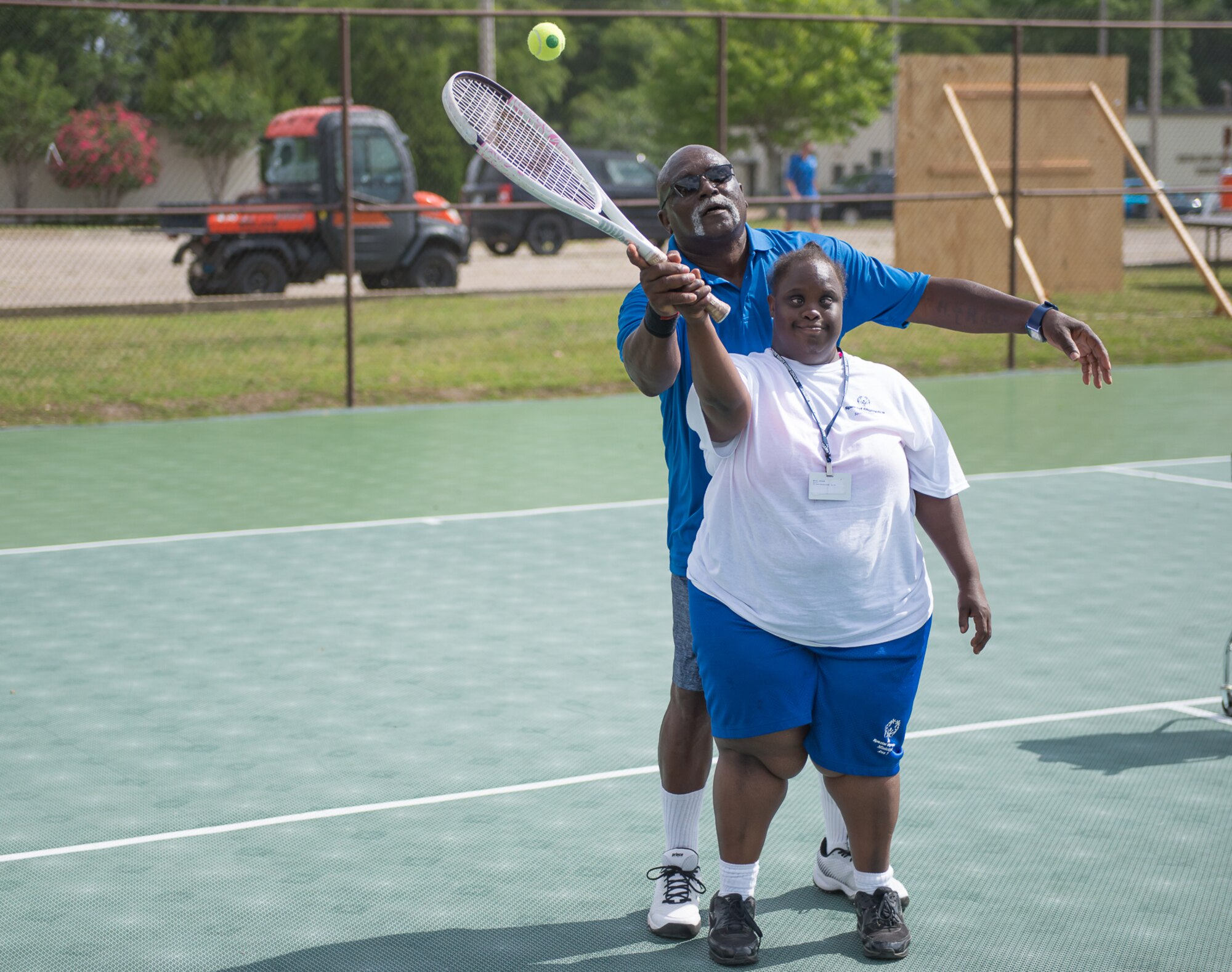 Henry Harris, Special Olympics Mississippi tennis director, helps Lashandra Woods, Area 7 athlete, during the Special Olympics Mississippi 2017 Summer Games at the tennis courts May 20, 2017, on Keesler Air Force Base, Miss. Founded in 1968, Special Olympics hosts sporting events around the world for people of all ages with special needs to include more than 700 athletes from Mississippi.  (U.S. Air Force photo by Andre’ Askew)