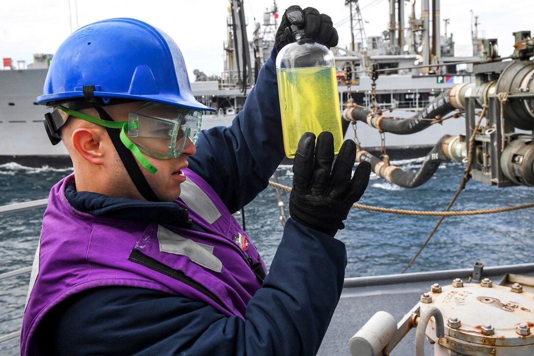Navy Petty Officer 2nd Class Luis Romero conducts a clear and bright test on fuel received from Henry J. Kaiser-class underway replenishment oiler USNS Rappahannock during a replenishment-at-sea aboard Arleigh Burke-class guided-missile destroyer USS Wayne E. Meyer in the western Pacific Ocean, May 13, 2017. Romero is a damage controlman. Navy photo by Petty Officer 3rd Class Kelsey L. Adams