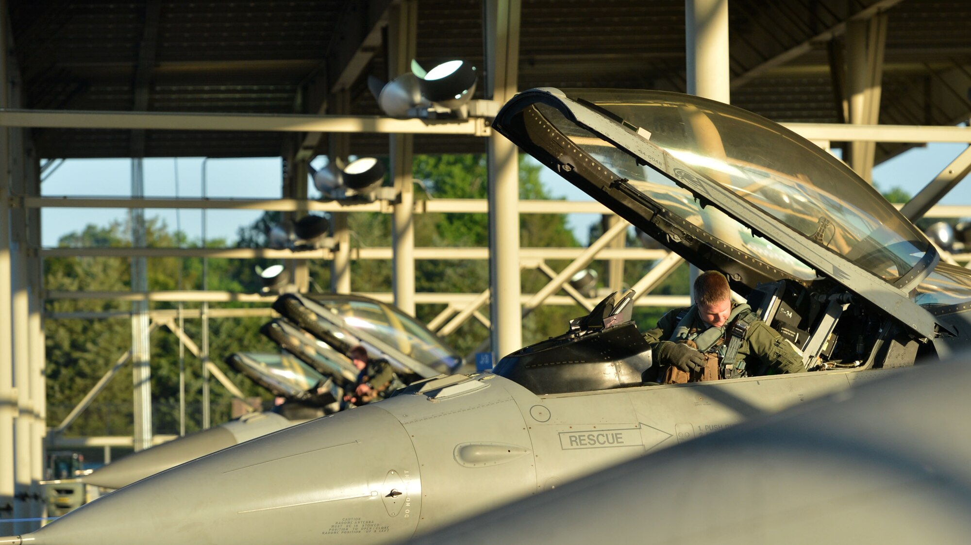 U.S. Air Force pilots assigned to the 20th Fighter Wing fasten themselves into their F-16CM Fighting Falcons during operational readiness exercise (ORE) Weasel Victory 17-07 at Shaw Air Force Base, S.C., May 15, 2017. The ORE gave pilots the opportunity to hone their flying skills in a simulated deployed environment. (U.S. Air Force photo by Airman 1st Class Christopher Maldonado)