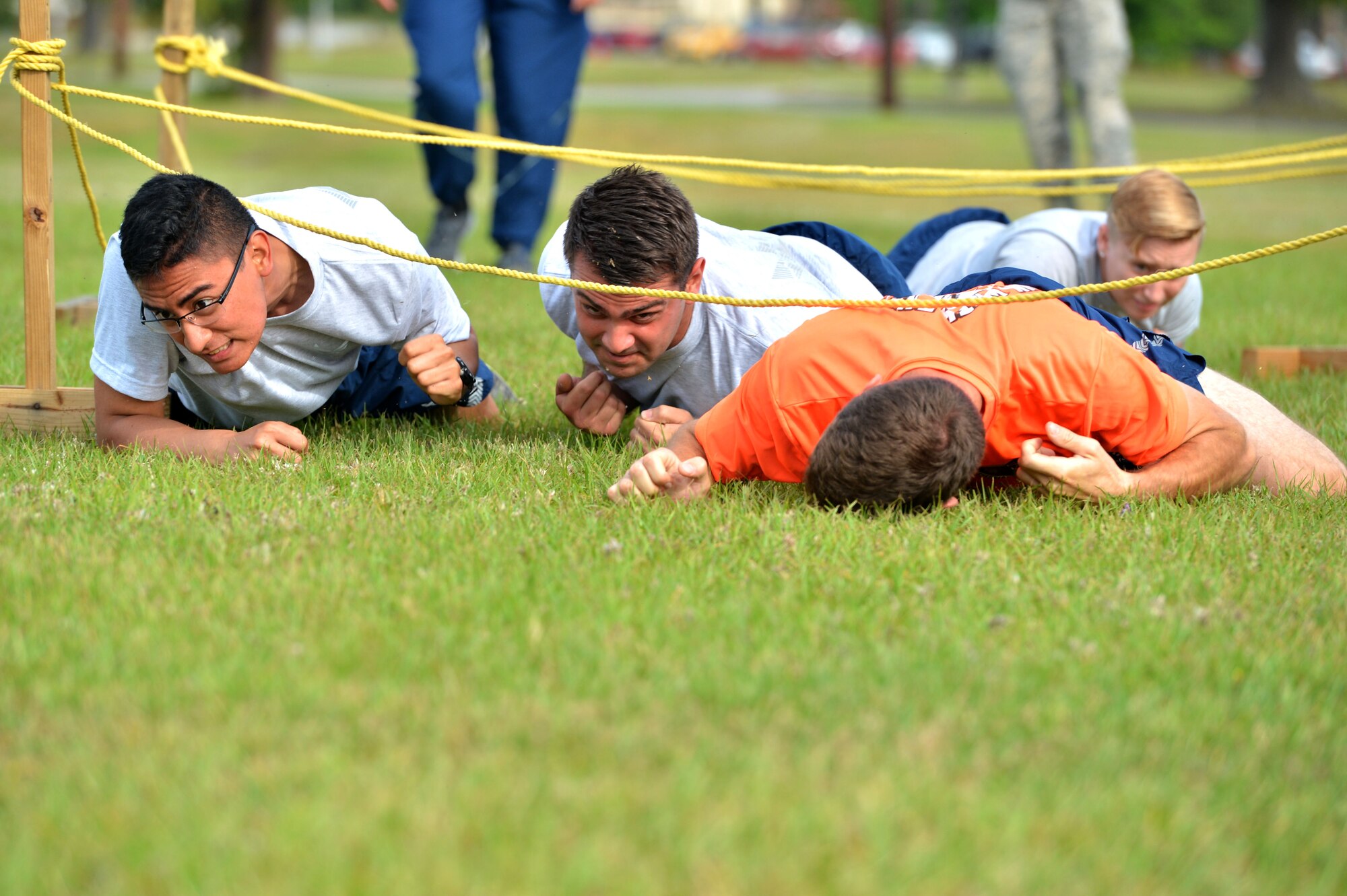U.S. Airmen assigned to the 20th Logistics Readiness Squadron perform a low-crawl as part of an obstacle course during the 20th Operations Group-hosted warrior day challenge at Shaw Air Force Base, S.C., May 19, 2017. Airmen performed low-crawls, tire flips, litter carries and trivia questions during the obstacle course. (U.S. Air Force photo by Airman 1st Class Christopher Maldonado)