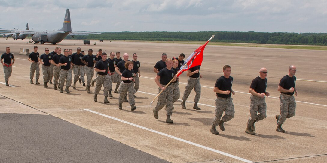 Members of the 96th Aerial Port Squadron and the 19th Logistics Readiness Squadron begin a 2.2 mile run at Little Rock Air Force Base, Ark., May 19, 2017. The “4th Annual Port Dawg Memorial Run” honored those in the air transportation career field across the Air Force who lost their lives in 2016. (U.S. Air Force photo by Master Sgt. Jeff Walston/Released)