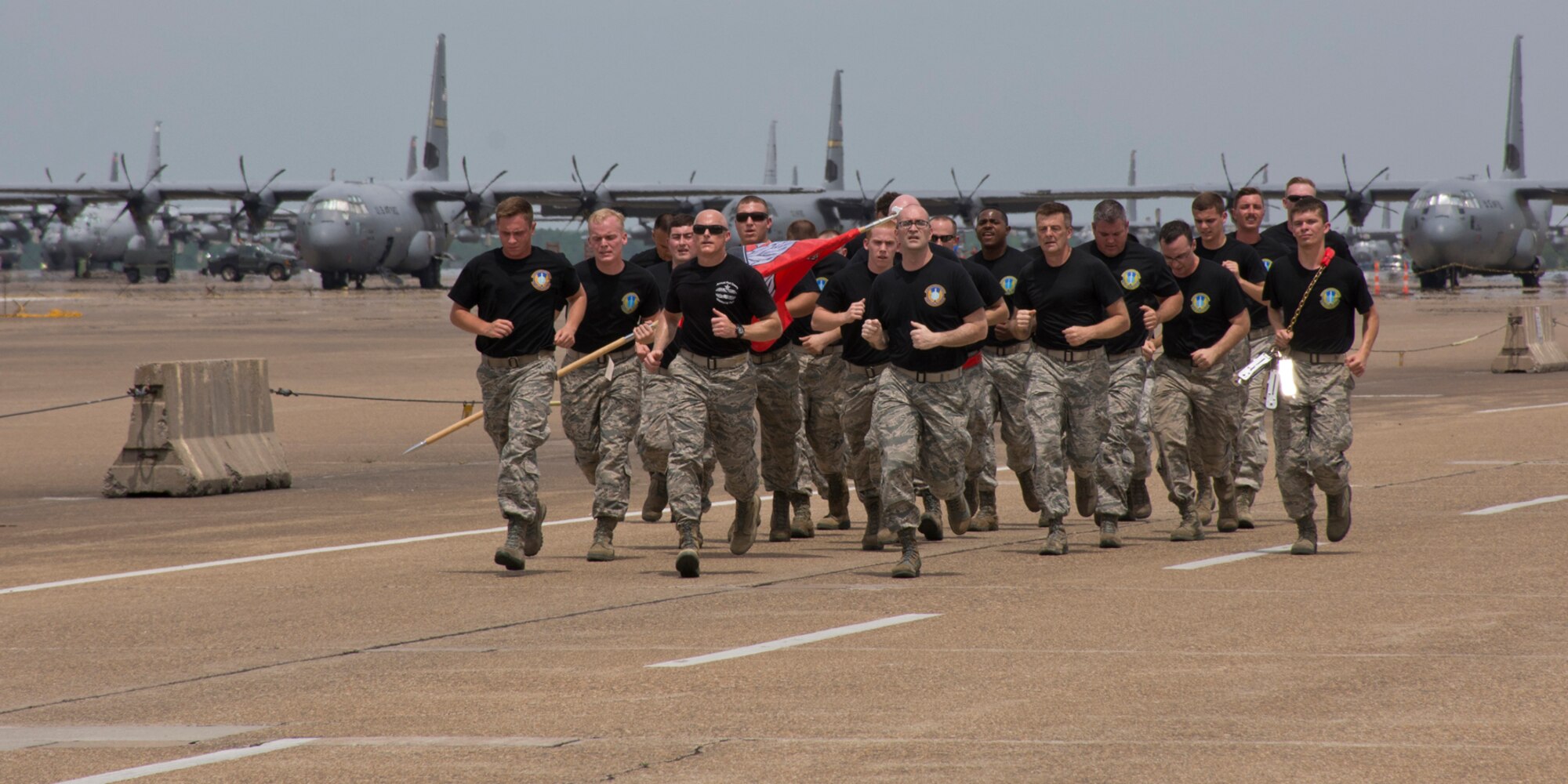 Members of the 96th Aerial Port Squadron and the 19th Logistics Readiness Squadron participate in a 2.2 mile run at Little Rock Air Force Base, Ark., May 19, 2017. The “4th Annual Port Dawg Memorial Run” honored those in the air transportation career field across the Air Force whose lives were lost in 2016. (U.S. Air Force photo by Master Sgt. Jeff Walston/Released)