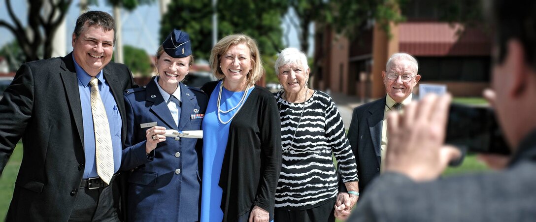 Air Force pilot 2nd Lt. Tayor Bye and her family share a moment following her Specialized Undergraduate Pilot Training graduation April 28.