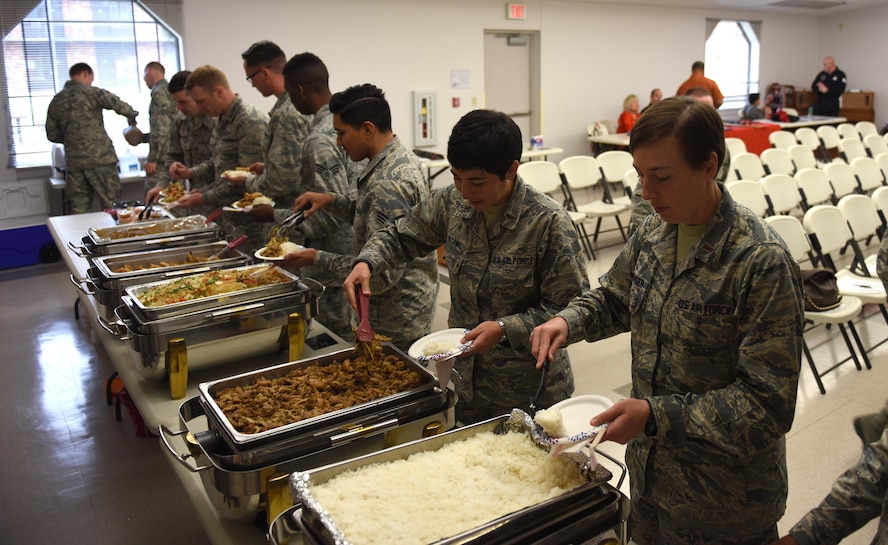 Airmen plate food at an Asian buffet at the beginning of the Asian-American and Pacific-Islander observation day at the Taylor Chapel on Goodfellow Air Force Base, Texas, May 23, 2017. Foods varied from different origin’s styles such as Vietnamese, Japanese and Filipino. (U.S. Air Force photo by Airman 1st Class Caelynn Ferguson/Released)