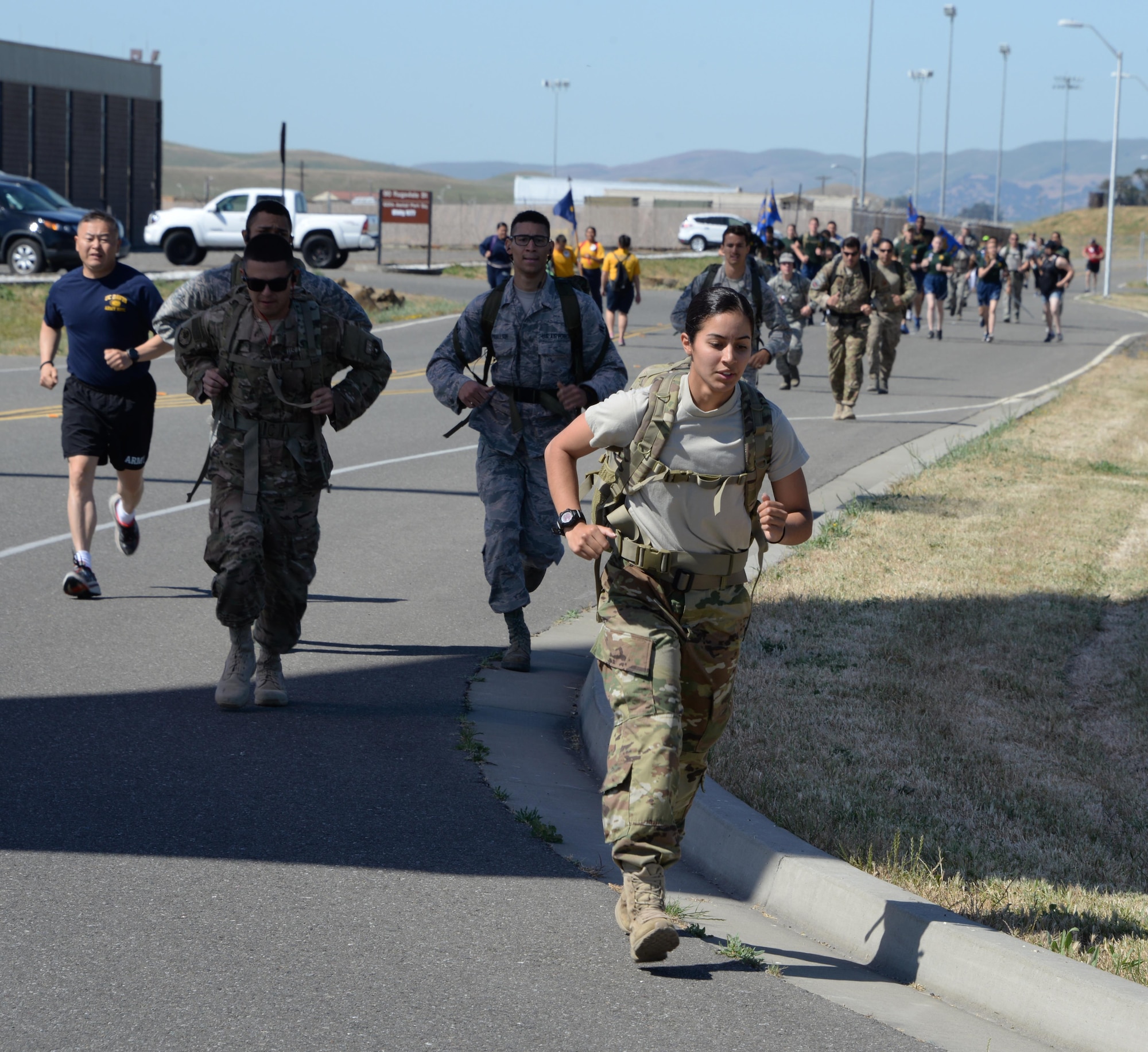 Military members and their families participate in the 7th Annual Gold Star Families Ruck March May 20, 2017 at Travis Air Force Base, Calif. The event, which featured 275 participants, is held every year by the Travis First Sergeant's Council to support Gold Star Families. (U.S. Air Force photo/Tech. Sgt. James Hodgman)