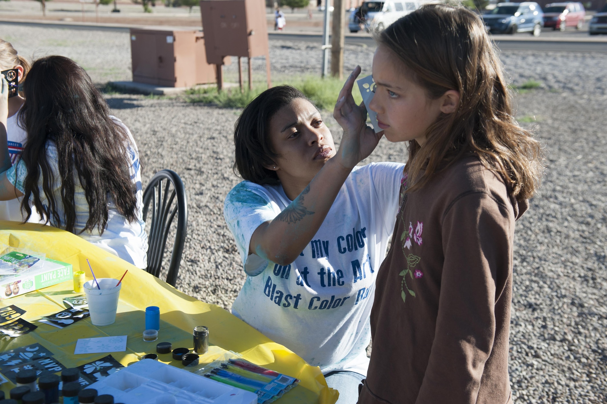 The Youth and Teen Center hosted the Art Blast color run 5K and the America’s Armed Forces Kids fun run on at Holloman Air Force Base, N.M on May 20, 2017. Volunteers set up tables at the fitness center outdoor track with face paint and shirts to hand out to the race participants. (U.S. Air Force photo by Airman 1st Class Ilyana A. Escalona)