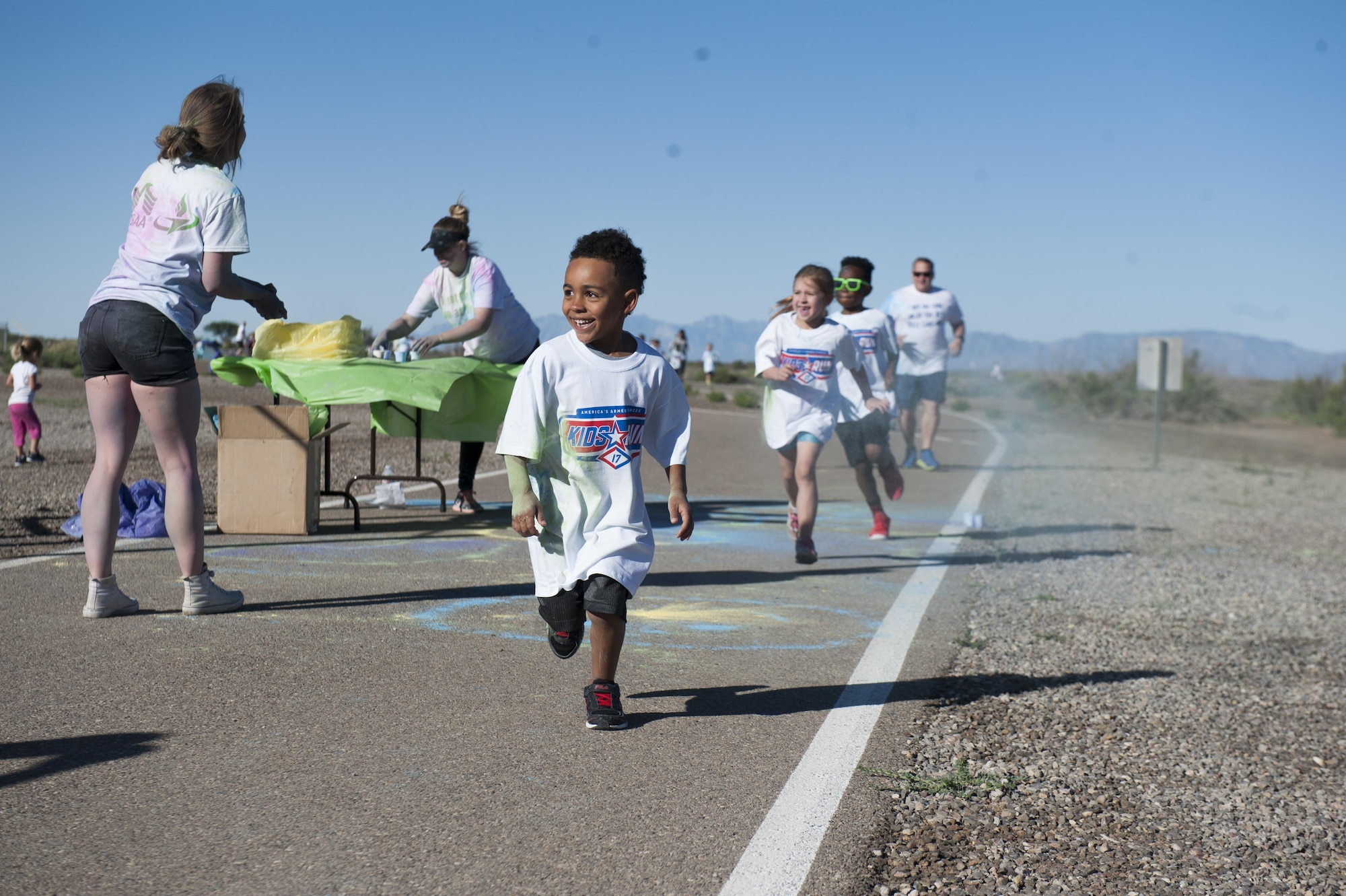 The Youth and Teen Center hosted the Art Blast color run 5K and the America’s Armed Forces Kids fun run at Holloman Air Force Base, N.M on May 20, 2017. During the run, volunteers set up tables along the track with various colored paint powder to toss at the runners transforming their fresh white shirts into a colorful canvas. (U.S. Air Force photo by Airman 1st Class Ilyana A. Escalona)
