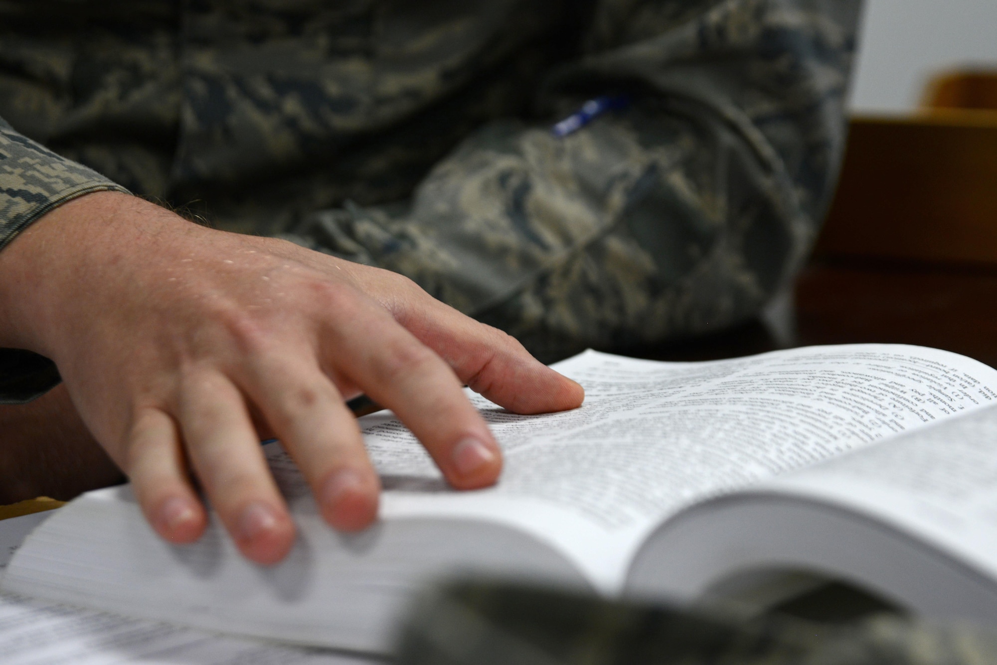 U.S. Air Force Senior Airman Quest Largent, 20th Fighter Wing Judge Advocate (JA) military justice paralegal, reads from a courts-martial manual at Shaw Air Force Base, S.C., May 9, 2017. The manual details punitive articles individuals can be charged under and provides JA Airmen information on how to write the charges. (U.S. Air Force photo by Airman 1st Class Kathryn R.C. Reaves)