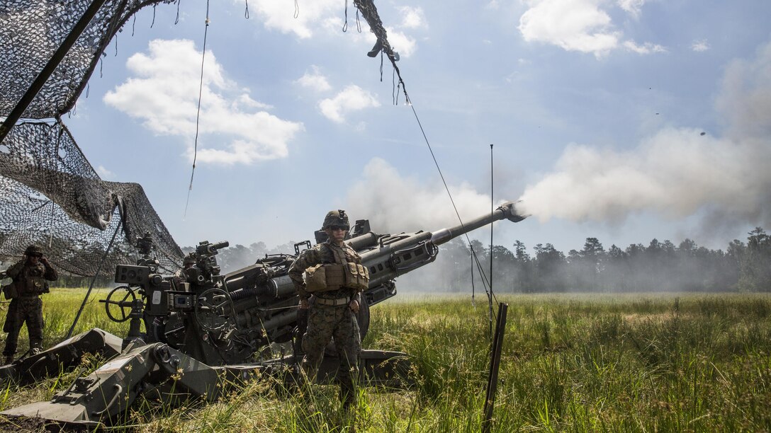A Marine with 2nd Battalion, 10th Marine Regiment, pulls the cord to fire an M777 Howitzer for a fire mission at Marine Corps Base Camp Lejeune, N.C., May 16, 2017. The Marines are participating in Burmese Chase, an annual, multi-lateral training exercise between U.S. armed forces and NATO members. 