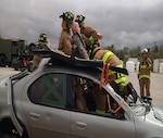 Firefighters with the South Dakota Army National Guard’s 216th and 451st Engineer Detachments extract a mannequin from a vehicle as a part of their annual training operations near Rapid City, S.D., May 9, 2017. The firefighters of the 216th are scheduled to deploy to Romania in July. (U.S. Army National Guard photo by Sgt. Austin Pearce)