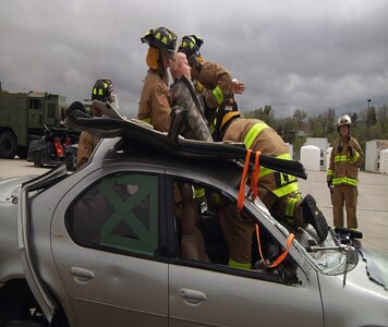 Firefighters with the South Dakota Army National Guard’s 216th and 451st Engineer Detachments extract a mannequin from a vehicle as a part of their annual training operations near Rapid City, S.D., May 9, 2017. The firefighters of the 216th are scheduled to deploy to Romania in July. (U.S. Army National Guard photo by Sgt. Austin Pearce)