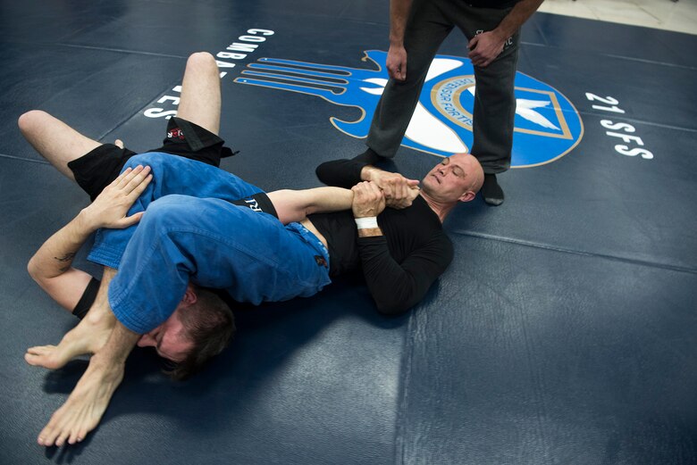 PETERSON AIR FORCE BASE, Colo. – Lt. Col. Matt Wingert, 310th Operations Group standards and evaluations chief, applies an arm bar to his opponent during a combatives tournament for National Police Week, May 18, 2017, at Peterson Air Force Base, Colo. The combatives tournament was one of several events the 21st Security Forces Squadron hosted for Police Week, May 15-19, including a distracted driving simulator, obstacle course, and BBQ. (U.S. Air Force photo by Steve Kotecki)