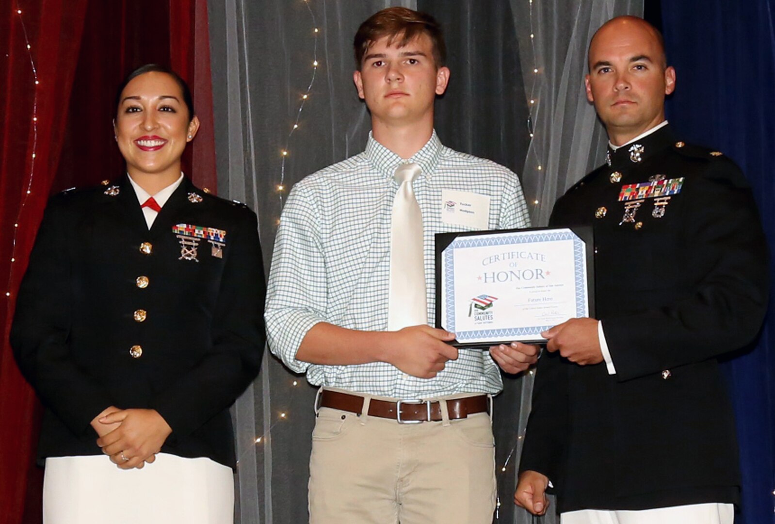 Marine Maj. Christopher Richardella and Capt. Kimberly Monge pose with Tucker Hodgson, a future Marine, who was honored during Our Community Salutes-San Antonio’s 6th Annual “A Night in Your Honor” held in the Rosenberg Sky Room at the University of the Incarnate Word.  Each future service member received an Our Community Salutes certificate and challenge coin from USAA.