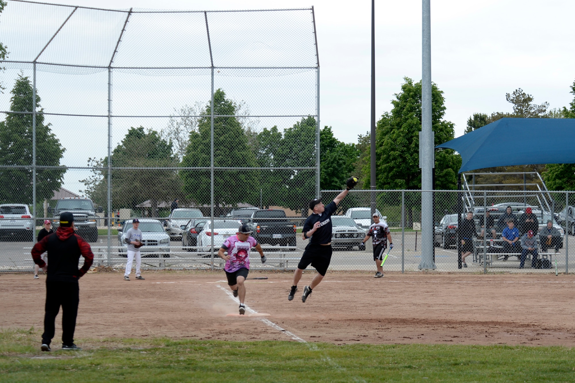 First baseman Tech. Sgt. Robert Sasseen, 75th Security Forces Squadron, makes a play during a softball game May 16 at Hill Air Force Base, Utah. The Defenders Challenge Softball Tournament was organized by 75th Security Forces Airmen as one of several events celebrating National Police Week. (Air Force photo/Todd Cromar)