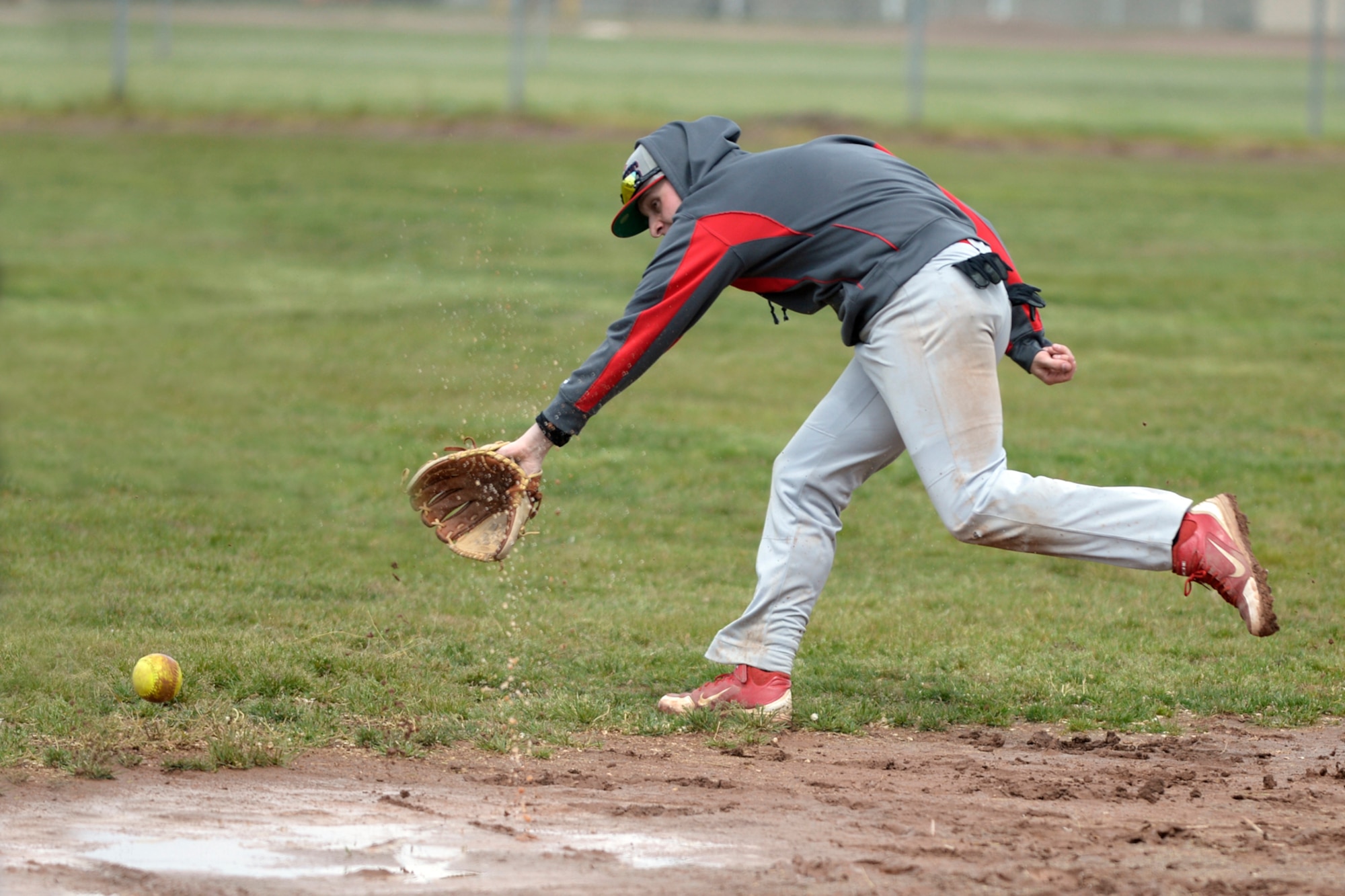 Airman 1st Class Zachary Quicke, 388th Operations Support Squadron, fields a hit down the third base line during a softball game May 16 at Hill Air Force Base, Utah. The Defenders Challenge Softball Tournament was organized by 75th Security Forces Airmen as one of several events celebrating National Police Week. (Air Force photo/Todd Cromar)