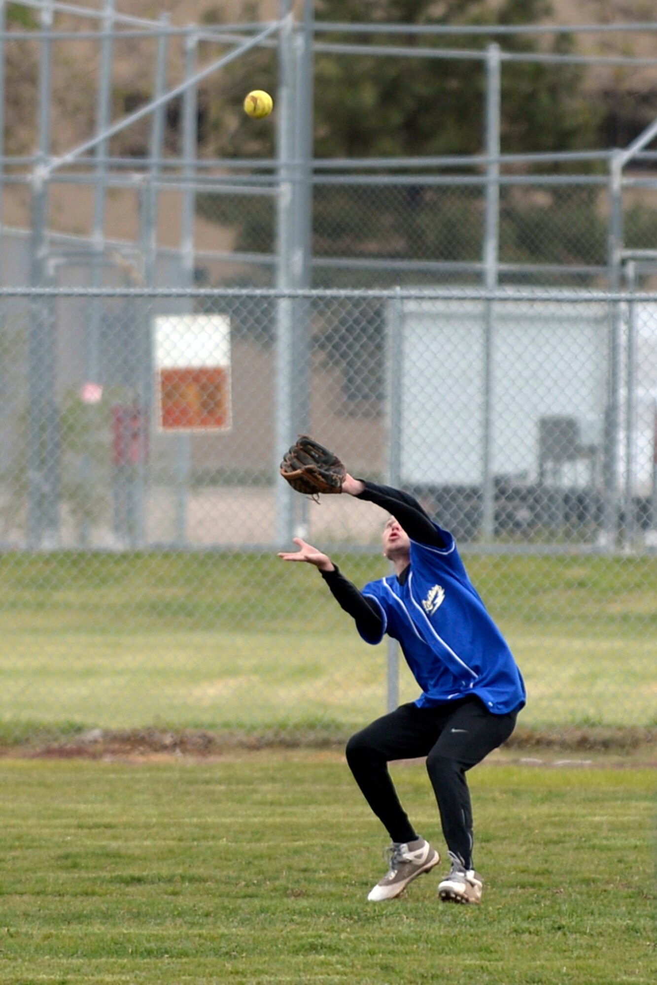 Airman Ryan Joplin, 388th Operations Support Squadron, catches a fly ball to right field during a softball game May 16 at Hill Air Force Base, Utah. The Defenders Challenge Softball Tournament was organized by 75th Security Forces Airmen as one of several events celebrating National Police Week. (Air Force photo/Todd Cromar)