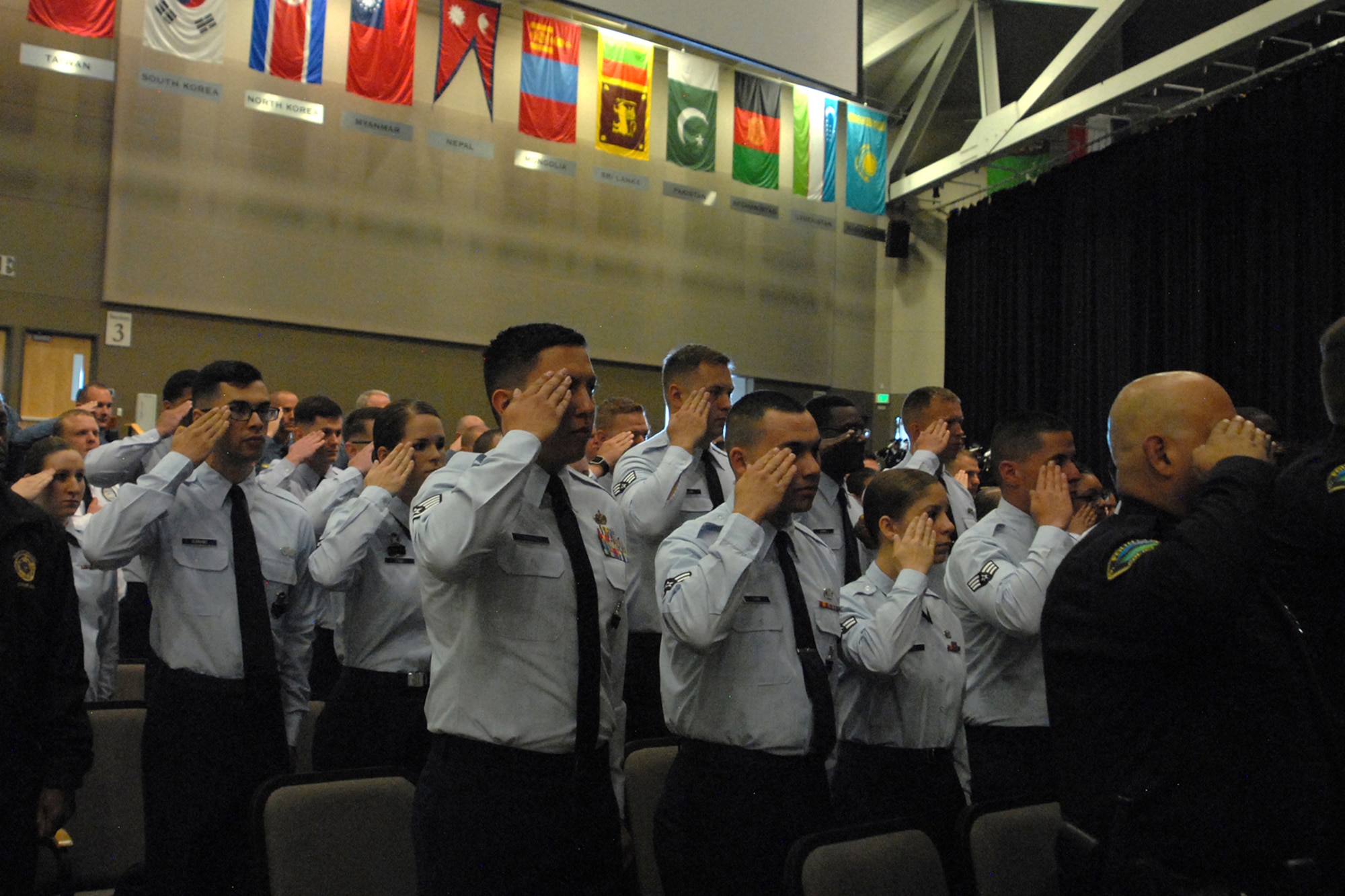COLORADO SPRINGS, Colo.-- Members of the 21st Security Forces Squadron along with fellow defenders and area law enforcement from across the region salute during the national anthem at the Pikes Peak Region Peace Officers' Memorial in Colorado Springs, Colo., May 19, 2017. The memorial service is part of Police Week, which celebrates the lives and sacrifices of area law enforcement through different activities. (U.S. Air Force photo by Shellie-Anne Espinosa)