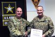 Maj. Gen. William Lee, commanding general, 3rd Medical Command (Deployment Support), presents the Maj. Gen. Lewis Aspey Mologne Award to Col. Robert E. Suter, commander, 3rd Medical Command (Deployment Support) Forward, at Camp As Sayliyah, Qatar, April 20, 2017. Suter was selected by the Office of the Surgeon General to receive the award. It is presented annually to one Active and one Reserve Medical Corps officer who the selection board feels best emulates Mologne by exhibiting a balance between outstanding leadership in military medicine and leadership in academics on a national level.