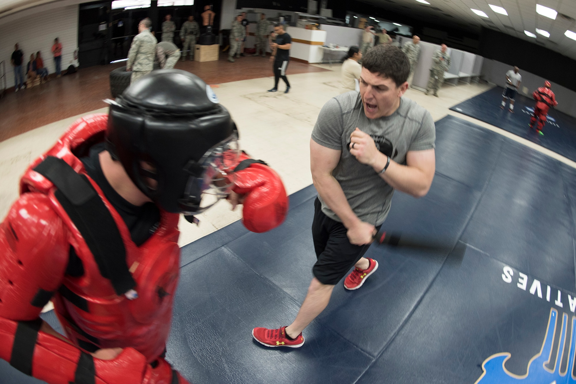PETERSON AIR FORCE BASE, Colo. – Team Pete Airmen complete one minute of non-lethal combative area during an obstacle course for National Police Week, May 18, 2017 at Peterson Air Force Base, Colo. The obstacle course was one of several events the 21st Security Forces Squadron hosted for Police Week, May 15-19, including a distracted driving simulator, combatives tournament, and BBQ. (U.S. Air Force photo by Steve Kotecki)