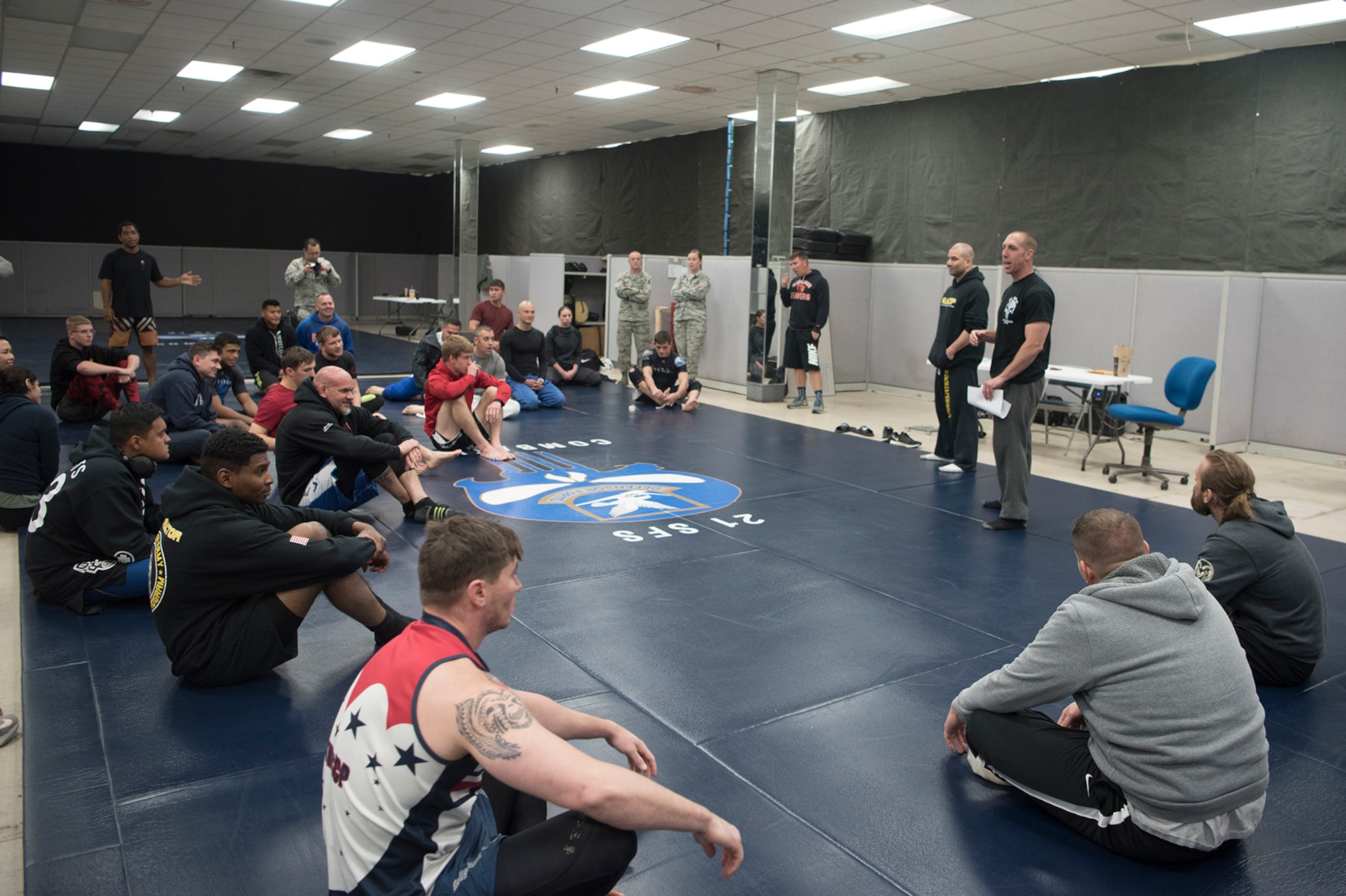 PETERSON AIR FORCE BASE, Colo. – Team Pete Airmen receive a safety briefing before a combatives tournament for National Police Week, May 18, 2017, at Peterson Air Force Base, Colo. The combatives tournament was one of several events the 21st Security Forces Squadron hosted for Police Week, May 15-19, including a distracted driving simulator, obstacle course, and BBQ. (U.S. Air Force photo by Steve Kotecki)