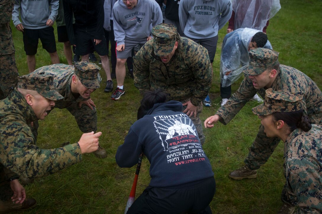 Marines motivate a Marine enlistee during a dizzy-izzy challenge during the annual Recruiting Station Portsmouth All-Hands Pool Function at Fort Devens, Mass., May 14, 2017. The function is a two-day event that helps prepare the station's enlistees for recruit training.