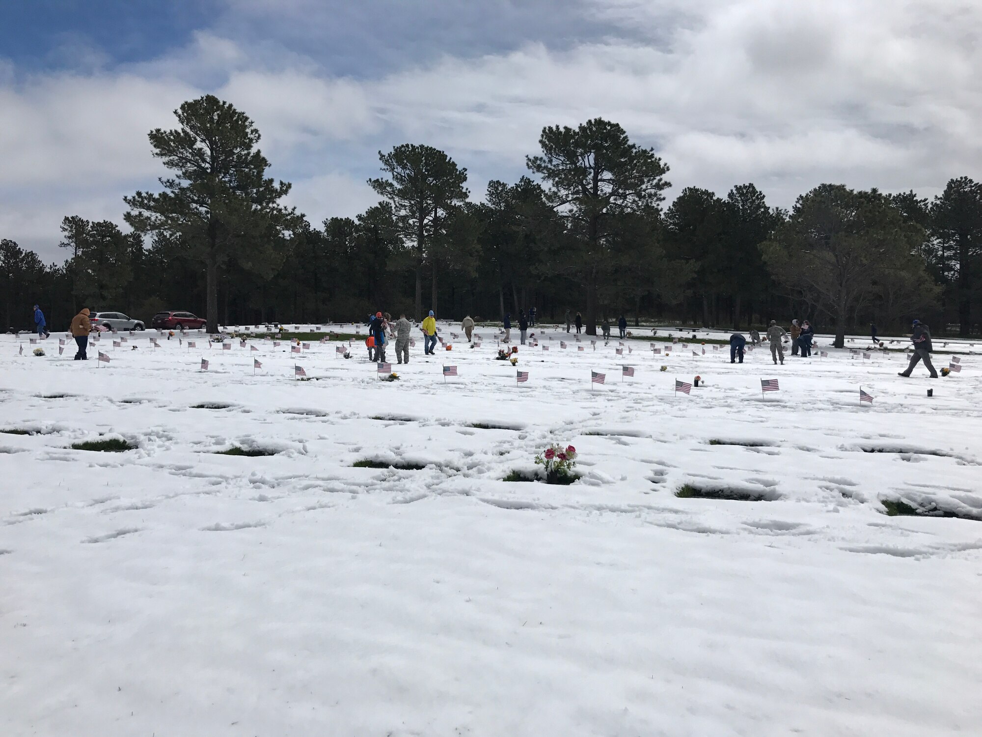 Approximately 40 Peterson Air Force, Colo., Airmen participate in placing over 1200 American flags on grave sites, May 19, 2017, at the U.S. Air Force Academy Cemetery, Colo. The annual event brings together volunteers from Colorado Springs, Colo., to place American flags in honor of Memorial Day. (Courtesy photo by Airman 1st Class Cynthia Munoz)