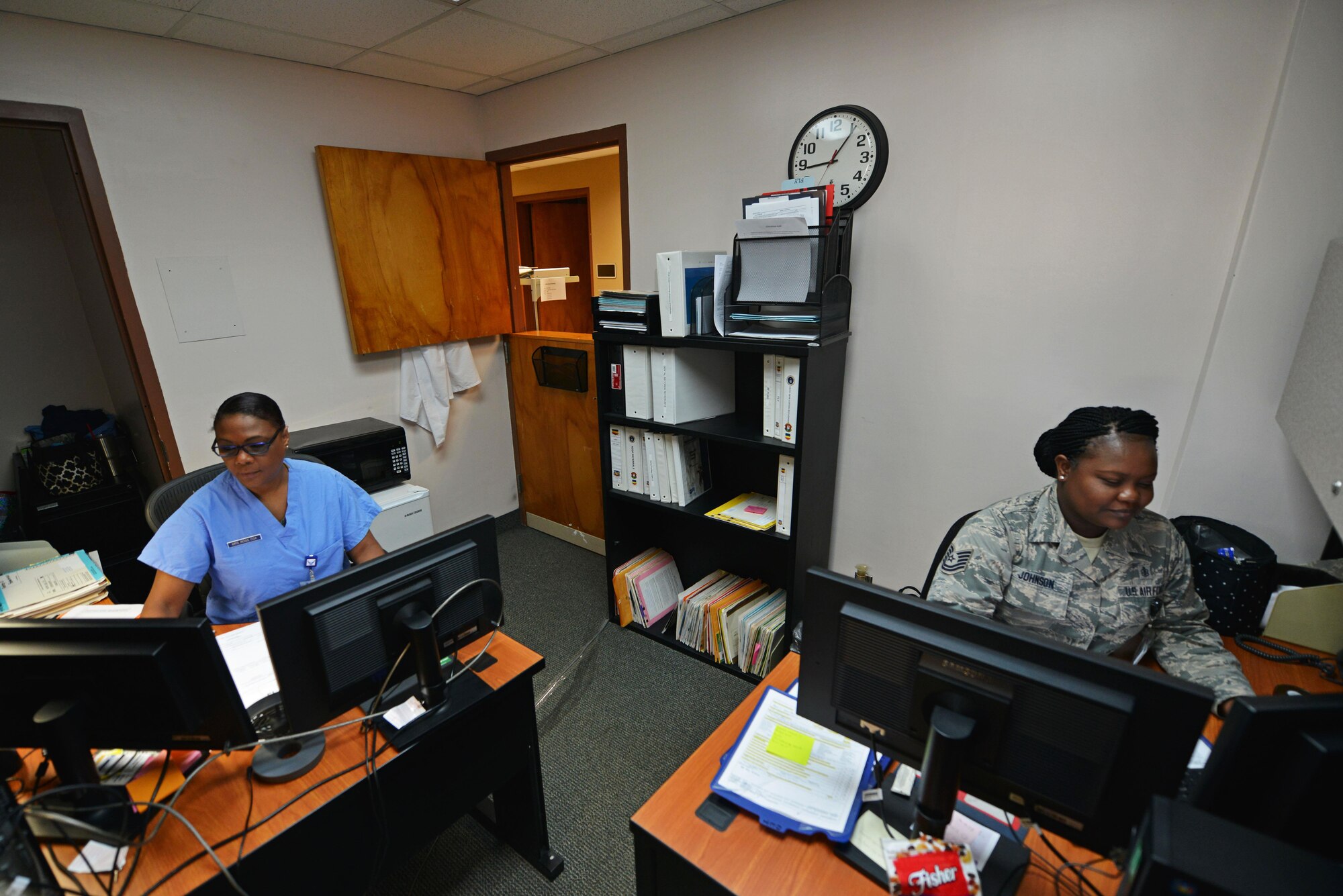 U.S. Air Force Tech. Sgt. Deonna Johnson, 20th Dental Squadron (DS) records and reception noncommissioned officer in charge, right, templates and sends out record requests while Beverly Ross, 20th DS active duty dental program referral manager, works on referrals at Shaw Air Force Base, S.C., May 18, 2017. Part of the dental support flight, Johnson acts as a liaison between the 20th DS and unit deployment managers, ensuring annual appointments are scheduled for every service member. Ross is responsible for all dental referrals to off-base clinics, ensuring Team Shaw members get the care they need. (U.S. Air Force photo by Airman 1st Class Destinee Sweeney)