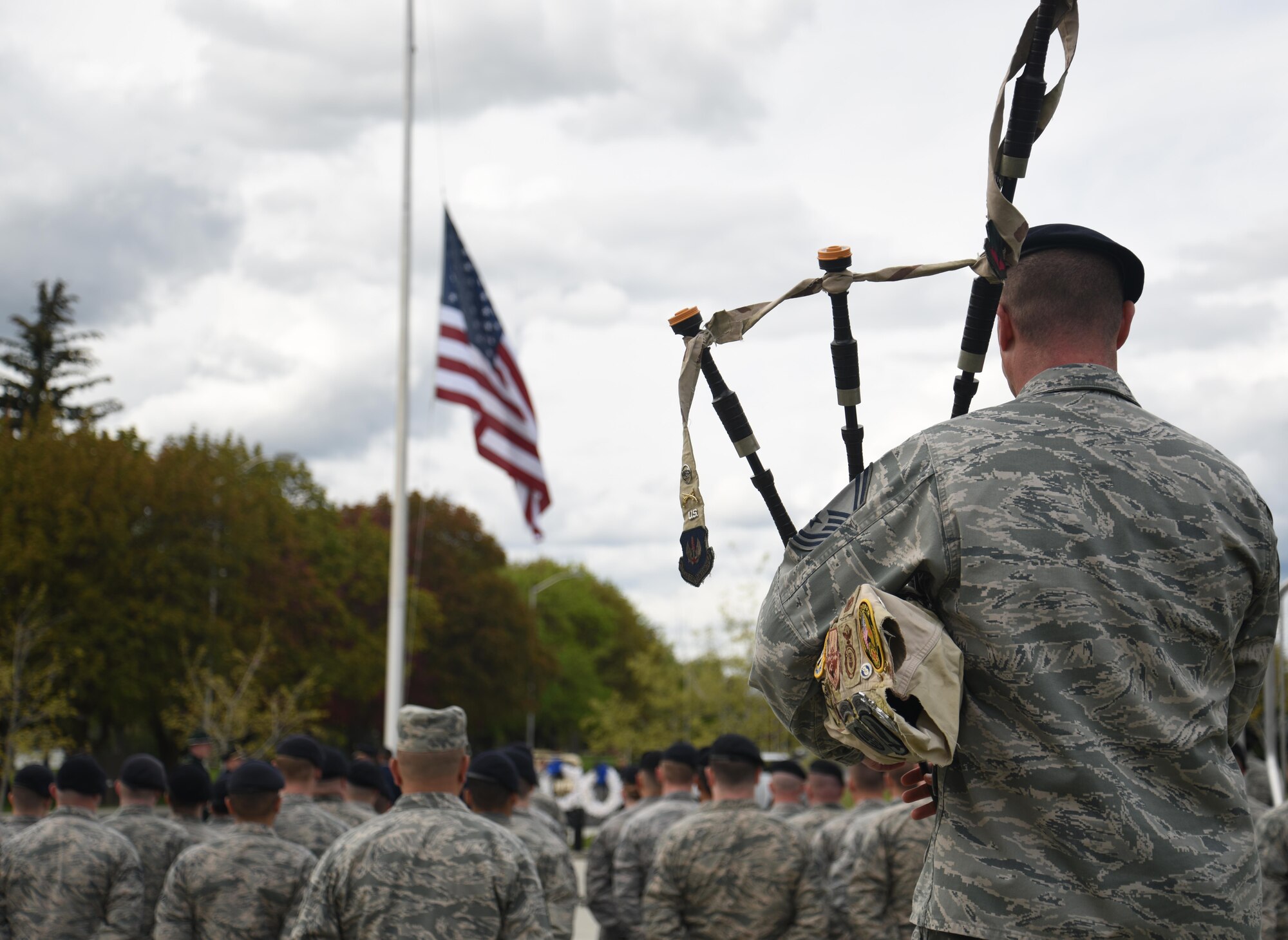 Airmen from the 92nd Security Forces Squadron stand in formation before the flag is lowered during a memorial retreat ceremony during National Police Week May 15, 2017, at Fairchild Air Force Base, Washington. The retreat is a special ceremony during National Police Week in honor of fallen law enforcement professionals. (U.S. Air Force photo/Staff Sgt. Samantha Krolikowski)