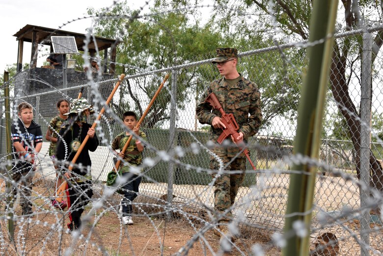 U.S. Marine Corps Lance Cpl. Noah Tait, Goodfellow Marine Corps Detachment student, starts a patrol with children during Operation: Kids Investigating Deployed Services at Camp Sentinel on Goodfellow Air Force Base, Texas, May 20, 2017. Each child had chance to understand what the armed services go through during a deployment. (U.S. Air Force photo by Staff Sgt. Joshua Edwards/Released)