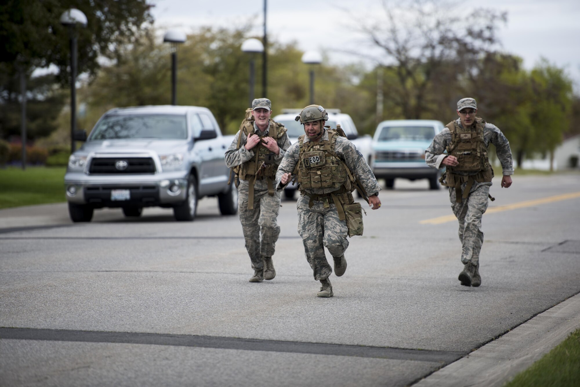 92nd Civil Engineer Squadron Explosive Ordnance Disposal Airmen approach the finish line of Fairchild’s National Police Week 5k Ruck/Run at Miller Park May 17, 2017, at Fairchild Air Force Base, Washington. National Police Week pays respect to the men and women who gave their life in the line of duty to keep others safe. (U.S. Air Force photo/ Airman 1st Class Sean Campbell)