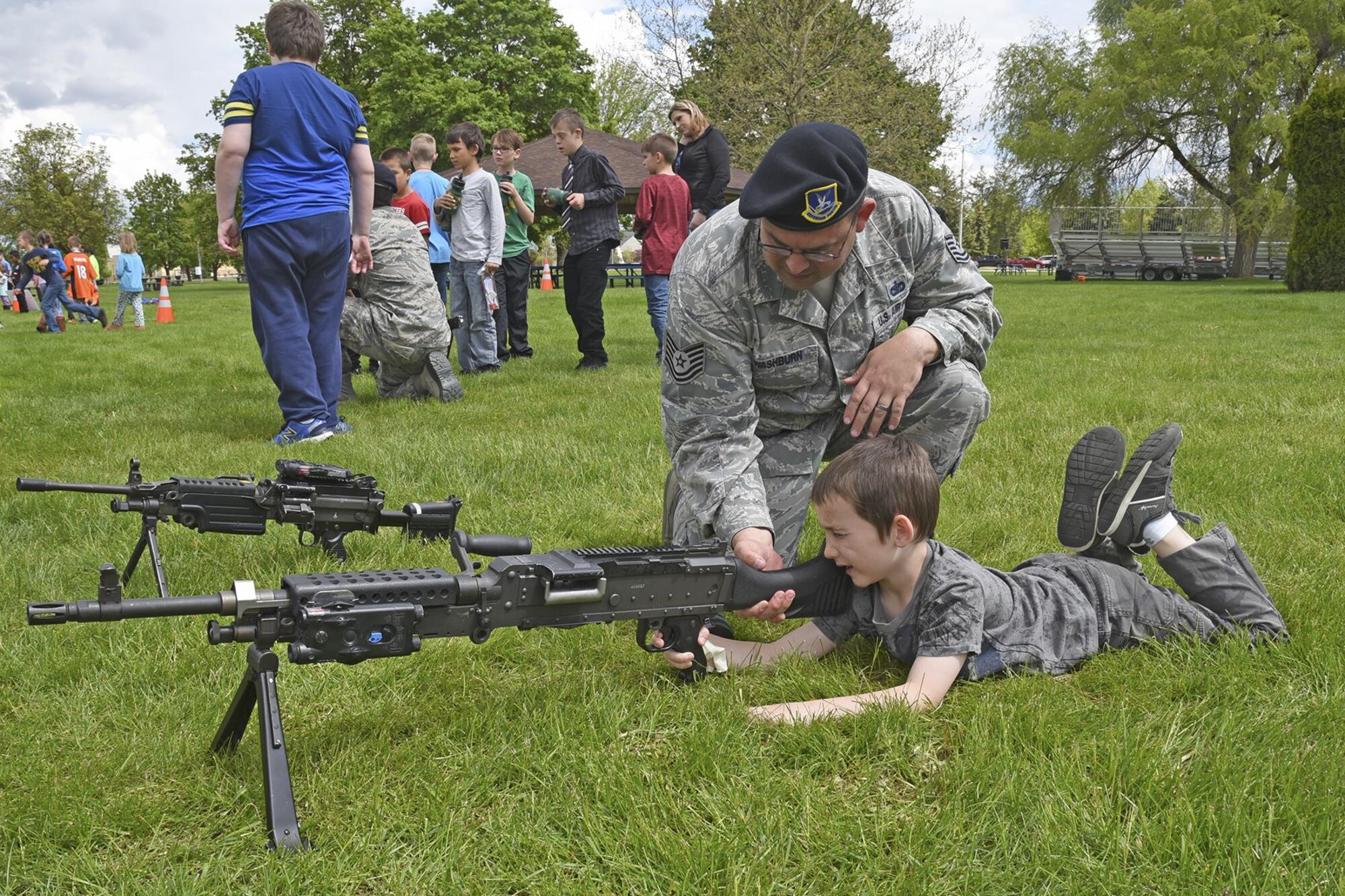 Tech. Sgt. Derek Washburn, 92nd Security Forces Squadron NCO in charge of operations, works with Michael Anderson Elementary students during the Law Enforcement Exposition May 18, 2017, at Fairchild Air Force Base, Washington.  The expo was part of National Police Week, which pays special recognition to law enforcement officers who lost their lives in the line of duty for the safety and protection of others. (U.S. Air Force photo/Senior Airman Mackenzie Richardson)