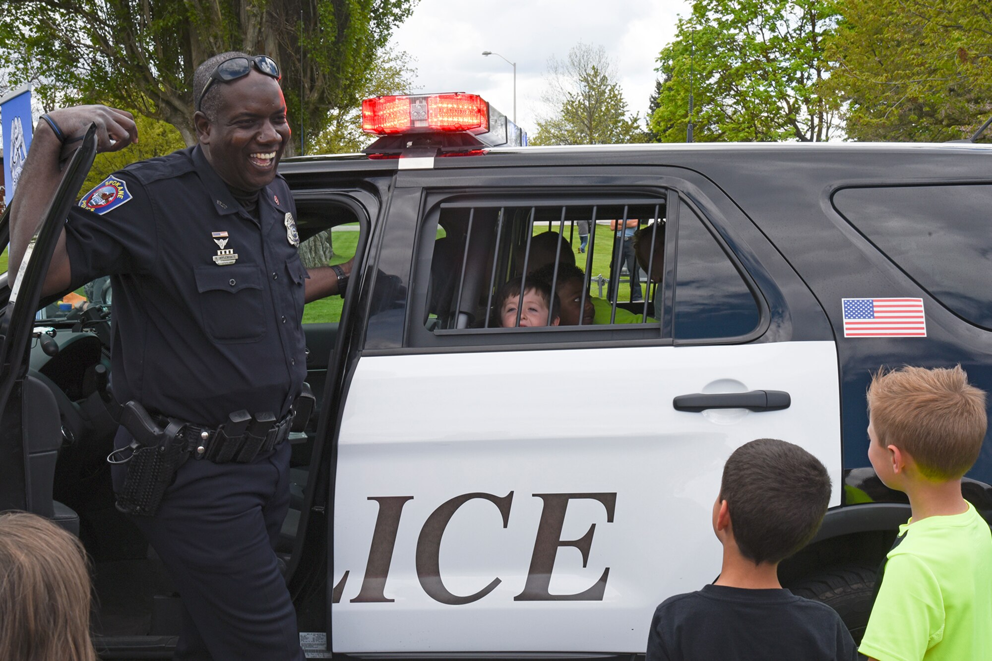 City of Spokane Police Department Officer Ken Applewhaite shows Michael Anderson Elementary students the inside of a patrol vehicle during the National Police Week Law Enforcement Exposition May 18, 2017, at Fairchild Air Force Base, Washington. The 92nd Security Forces Squadron hosted numerous events for Team Fairchild and their families to enjoy, including the expo which featured an obstacle course, scavenger hunt and Military Working Dog demonstrations. (U.S. Air Force photo/Senior Airman Mackenzie Richardson)