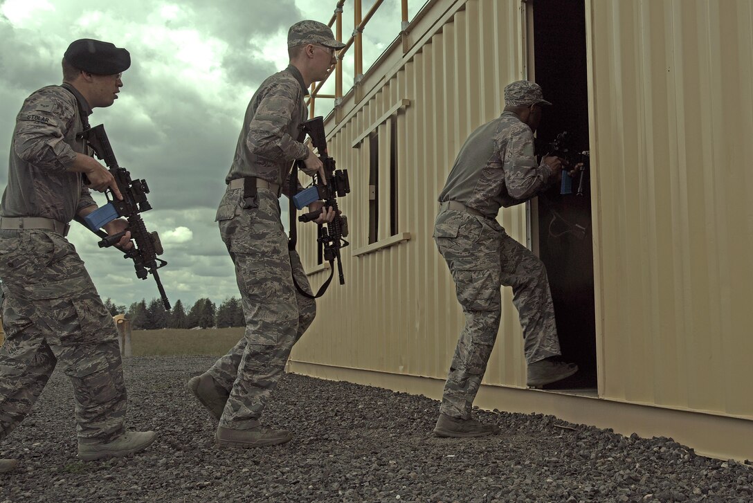 92nd Security Forces Squadron Airmen breach a door May 19, 2017, at Fairchild Air Force Base, Washington. Approximately 20 Airmen competed in a time trialed shoot house competition as part of National Police Week. (U.S. Air Force photo/Senior Airman Nick J. Daniello)