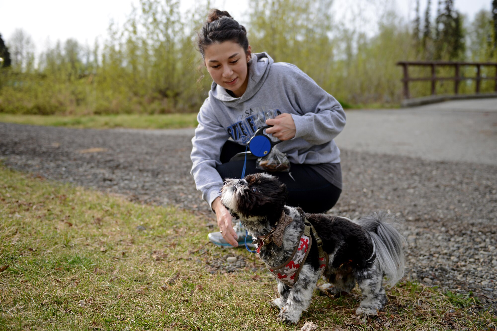 Dani Wildermuth and Teeko the dog bask in the cool Alaska spring evening following the Pet Fun Run 5K at Eagleglen Fitness Park at Joint Base Elmendorf-Richardson, May 19, 2017. More than 40 athletes raced with their canine companions at the fun run. First, second and third place finishers received prizes, though all pets were given goodie bags. 