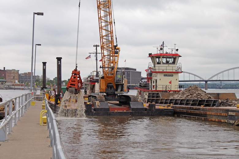 Mississippi River Project maintenance crews with the U.S. Army Corps of Engineers, Rock Island District demolish a portion of the lower guidewall at Locks and Dam 15 in Rock Island, Illinois. Removing the concrete will prevent the wall from falling into the river in an uncontrolled manner.