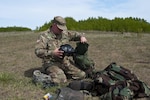 Sgt. Michael Whitehead, a chemical, biological, radiological and nuclear (CBRN) specialist with the 50th Chemical Company based in Somerset, New Jersey, collects his gas mask and other protective gear after a personal decontamination exercise May 19, 2017, during Maple Resolve 17 at Camp Wainwright, Alberta, Canada. 