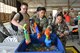 U.S. Airmen fill up water guns during the 2017 Combat Dining Out in Hangar 1200 at Shaw Air Force Base, S.C., May 19, 2017. During the event, Team Shaw members partook in water gun and water balloon fights. (U.S. Air Force photo by Airman 1st Class Destinee Sweeney)