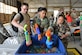 U.S. Airmen fill up water guns during the 2017 Combat Dining Out in Hangar 1200 at Shaw Air Force Base, S.C., May 19, 2017. During the event, Team Shaw members partook in water gun and water balloon fights. (U.S. Air Force photo by Airman 1st Class Destinee Sweeney)