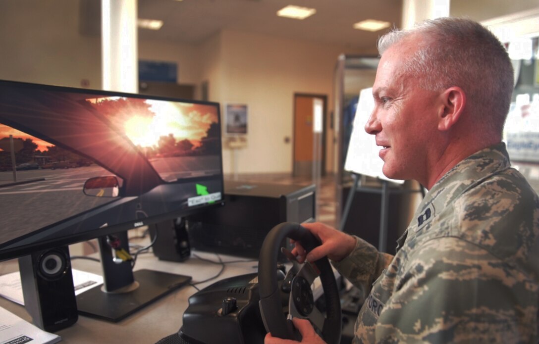 PETERSON AIR FORCE BASE, Colo. – Capt. John Boulware, 21st Space Wing chaplain, participates in a distracting driving simulator, May 17, 2017, at Peterson Air Force Base, Colo. Hosted by the 21st Security Forces Squadron, the program offers the driver a simulated experience on what it is like to drive with various distractions. The distracted driving simulator is one of several events by the 21st SFS for National Police Week including an obstacle course, combative tournament, BBQ and golf tournament. (U.S. Air Force photo by David Meade)