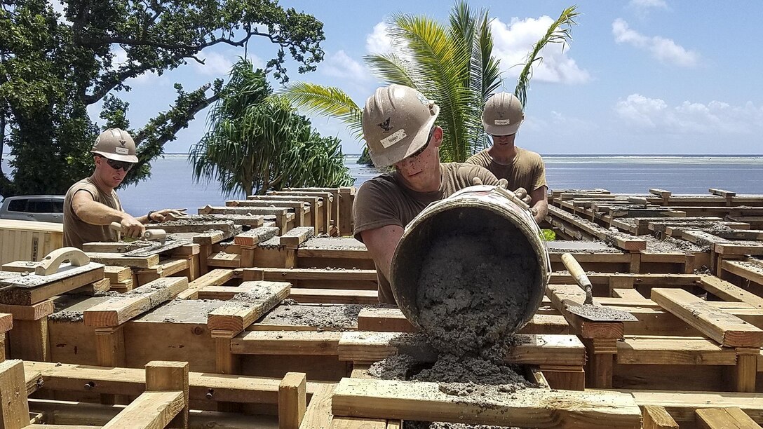 Navy Petty Officer 3rd Class Alexander Zebro pours cement for the bond beam of a health clinic that Naval Mobile Construction Battalion 1 personnel are building in Kosrae, Micronesia, May 16, 2017. Navy photo by Petty Officer Matthew Konopka