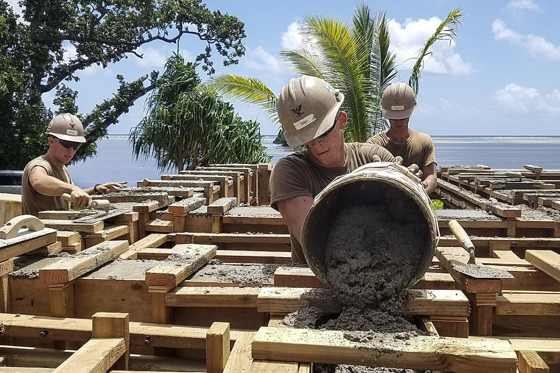 Navy Petty Officer 3rd Class Alexander Zebro pours cement for the bond beam of a health clinic that Naval Mobile Construction Battalion 1 personnel are building in Kosrae, Micronesia, May 16, 2017. Navy photo by Petty Officer Matthew Konopka