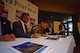 Col. Daniel Morgan, Joint Base Lewis-McChord garrison commander, signs the memorandum of agreement with local officials for a plan to create the McChord Field North Clear Zone during the South Sound Military and Communities Partnership council meeting May 11 at Eagles Pride Golf Course.