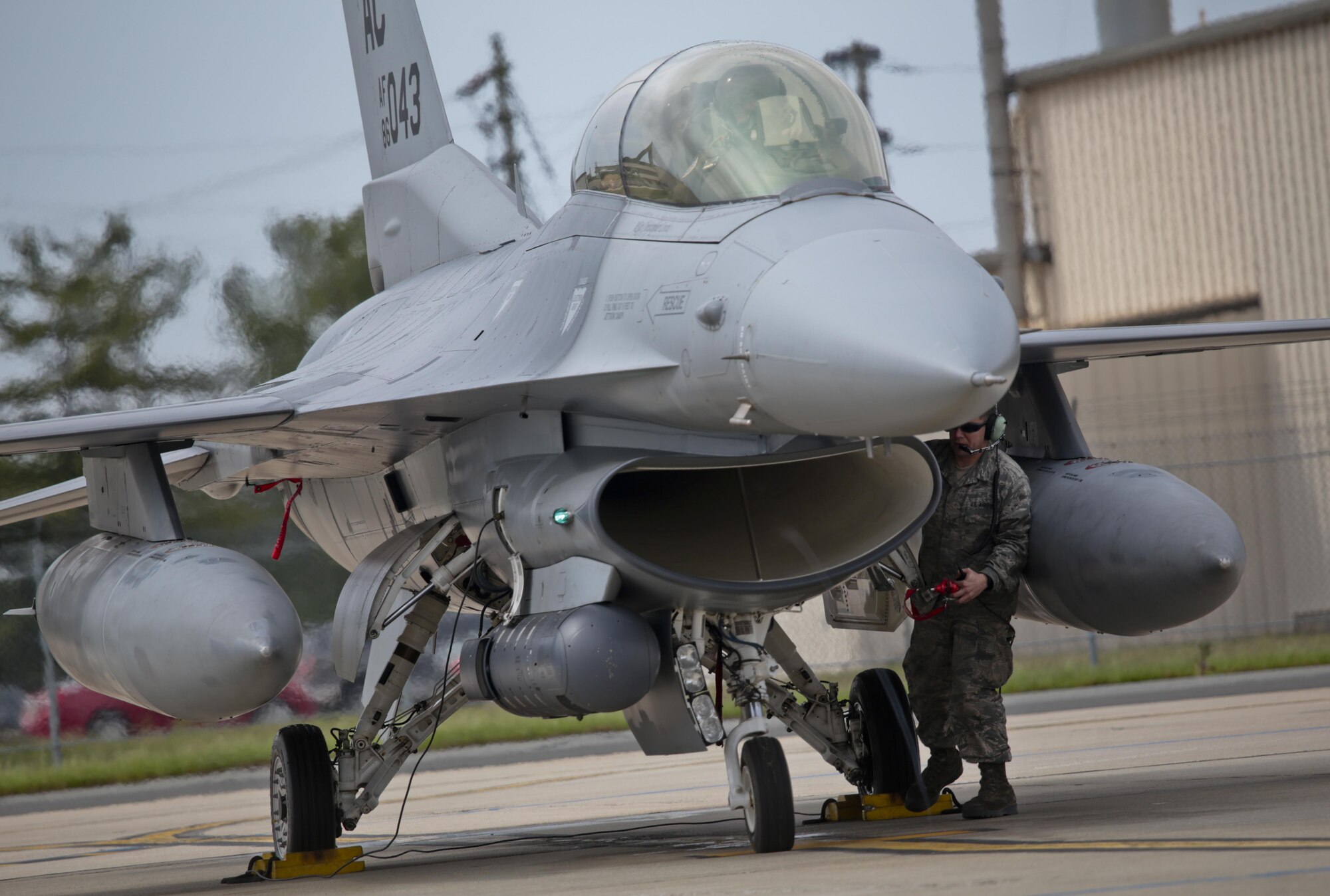 New Jersey Air National Guard Tech. Sgt. Sean Romero, an F-16 crew chief, communicates with Col. Bradford Everman, 119th Fighter Squadron Commander, while preparing his F-16D Fighting Falcon for a flight during a three-day Aeropsace Control Alert CrossTell live-fly training exercise at Atlantic City Air National Guard Base, N.J., May 23, 2017. Representatives from the Air National Guard fighter wings, Civil Air Patrol, and U.S. Coast Guard rotary-wing air intercept units will conduct daily sorties from May 23-25 to hone their skills with tactical-level air-intercept procedures. (U.S. Air National Guard photo by Master Sgt. Matt Hecht/Released)