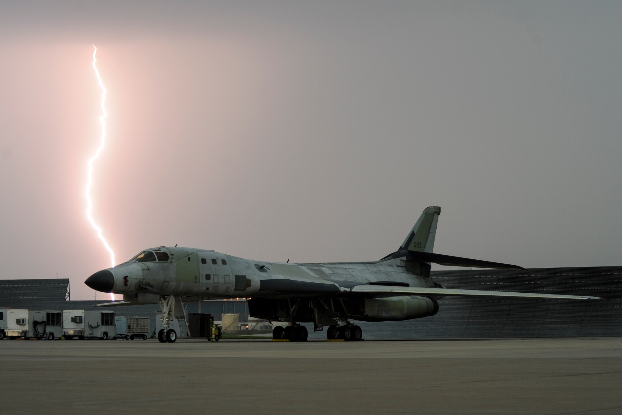 Lightning strikes behind a B-1B Lancer parked on the flight line as a major storm approaches Tinker Air Force Base, Oklahoma May 18, 2017. The B-1B is at Tinker undergoing depot level maintenance and has been stripped of a majority of its paint. (U.S. Air Force photo/Greg L. Davis)