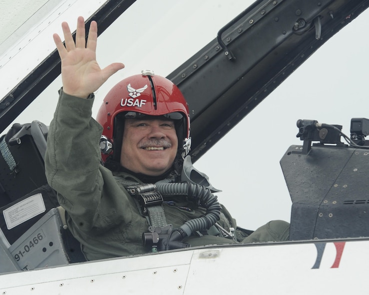 Maj. David Huff, Midwest City Police Officer, waves from the backseat of a Thunderbirds F-16D prior to a flight with Capt. Erik Gonsalvez, Thunderbird #8, team advance pilot/narrator May 19, 2017, Tinker Air Force Base, Oklahoma. Maj. Huff was honored as a Hometown Hero for his work with the Midwest City Police Department.(U.S. Air Force photo/Greg L. Davis)

