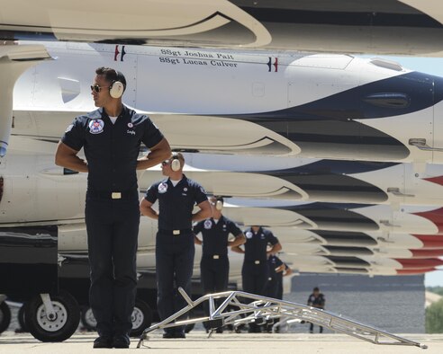 Staff Sgt. Aaron Langley, Thunderbird #1 F-16 crew chief, leads a row of crew chiefs during the highly-choregraphed start-up procedures as part of their performance during Tinker Air Force Base's Star Spangled Salute air show May 20, 2017, Tinker Air Force Base, Oklahoma. The Thunderbirds performed to a record-breaking crowd during both days of the show. (U.S. Air Force photo/Greg L. Davis)