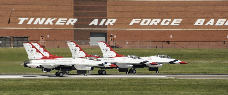 Four Thunderbird F-16s accelerate down the runway with the Tinker Air Force Base signage on building 3001 visible above them to begin their display during Tinker Air Force Base's Star Spangled Salute air show May 21, 2017, Tinker Air Force Base, Oklahoma. The Thunderbirds performed to record crowds during the weekend as the stars of the show. (U.S. Air Force photo/Greg L. Davis)