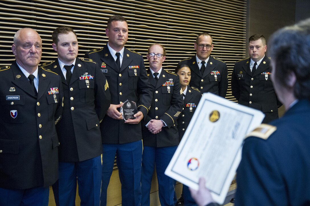 U.S. Army Reserve Soldiers from the 391st Military Police Battalion, of Columbus, Ohio, listen to a food service leader from the U.S. Army Reserve Command as she congratulates them on their award during a dinner ceremony for The Philip A. Connelly Awards in Chicago, Illinois on May 19, 2017. The Department of the Army’s Connelly Awards is an annual military competition, which uses military and civilian evaluators from the National Restaurant Association to recognize military units for excellence in Army food service. This year’s winner was the 391st MP Bn., under the 200th MP Command, representing the U.S. Army Reserve. Winning teams from the active components and National Guard also attended the dinner. (U.S. Army Reserve photo by Maj. Saphira Ocasio)